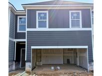 New construction townhome featuring a garage and modern gray siding at 216 Seward St # 93, Conyers, GA 30094
