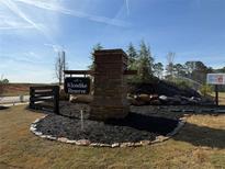 Klondike Reserve entrance sign with brick pillar and black mulch landscaping at 216 Seward St # 93, Conyers, GA 30094
