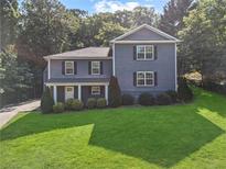 Charming two-story home featuring a lush green lawn and well-maintained landscaping at 2067 Kinridge Ct, Marietta, GA 30062