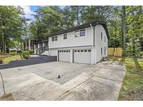 Charming two-story home with a two-car garage and freshly painted white brick at 4760 Silverdale Rd, College Park, GA 30349