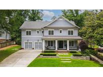 Charming two-story home with a manicured front yard and a two-car garage at 4048 Navajo Trl, Brookhaven, GA 30319