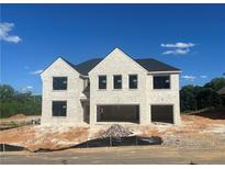 New construction of a two-story brick home featuring a two-car garage and classic architectural details at 4437 Hosch Reserve Ct, Buford, GA 30519