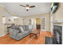 Cozy living room features a fireplace, ceiling fan, and open floor plan at 539 Mcgill Park Ne Ave, Atlanta, GA 30312