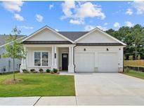 Charming single-story home with a well-manicured lawn, two-car garage and inviting front porch at 404 Vinca Nw Cir, Kennesaw, GA 30144