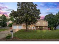 Charming two-story home with a well-manicured lawn and attached two-car garage at 618 Nw Summerville Dr, Lawrenceville, GA 30046