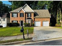 Charming two-story brick home with a well-manicured lawn and two car garage at 108 Northcutt Station Pl, Acworth, GA 30101