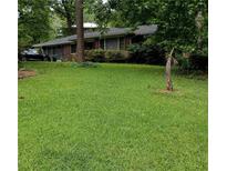Charming single-story home nestled on a lush green lawn with mature trees at 2493 Springdale Rd, Atlanta, GA 30315