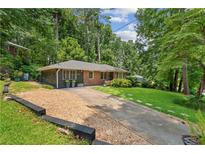 Charming single-story home with a brick facade and well-manicured lawn at 2493 Springdale Rd, Atlanta, GA 30315