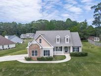 Charming two-story home with stone accents, well-manicured lawn and lovely landscaping details at 114 Saddle Wood Dr, Dallas, GA 30157