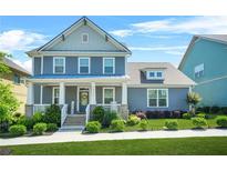 Charming two-story home with a welcoming front porch, well-manicured lawn, and beautiful landscaping at 9990 Blackfriars Rd, Douglasville, GA 30135