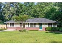 Charming single story home with a well-manicured lawn and mature trees offering shade at 2100 Shady Ln, Tucker, GA 30084