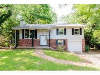 Charming two-story home featuring brick accents, gray siding, and a well-manicured lawn at 4339 Sasanqua Ct, Tucker, GA 30084