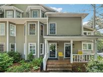 Charming townhome featuring a welcoming front porch and lush landscaping at 1416 Oakridge Cir, Decatur, GA 30033
