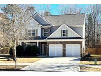 Charming two-story home featuring a brick facade, two-car garage, and meticulously maintained landscaping at 1029 Harvest Brook Dr, Lawrenceville, GA 30043