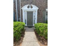 Inviting brick home entrance featuring a decorative doorway and well-maintained landscaping at 2858 Parkway Close, Lithonia, GA 30058