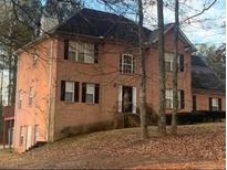 A charming two-story brick home with a well-maintained front yard and mature trees at 3796 Melvin Sw Dr, Atlanta, GA 30331