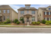 Charming two-story brick home with manicured landscaping and inviting front porch at 4204 Hardy Ave, Smyrna, GA 30082