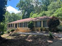 Charming single-story home features a manicured lawn and classic brick facade at 1093 Hasty Sw Ct, Lilburn, GA 30047