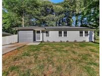 Charming single-story home featuring a modern gray brick facade and well-manicured lawn at 1770 Atherton Dr, Decatur, GA 30035