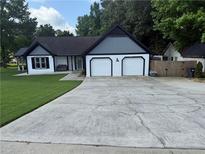Charming single-Gathering home with a well-maintained lawn and a two-car garage at 2303 Condor Dr, Lawrenceville, GA 30044