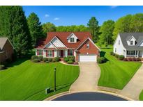 Charming brick home featuring lush landscaping, a two-car garage, and a well-manicured lawn at 3076 Harris Mill Ct, Duluth, GA 30096