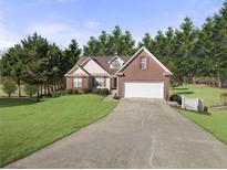 Charming brick home with a well-manicured lawn and a two-car garage, perfect for suburban living at 3076 Harris Mill Ct, Duluth, GA 30096