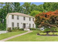 Charming two-story home with a brick facade, mature trees, and a well-manicured lawn at 1560 Boxwood Nw Trce, Acworth, GA 30102