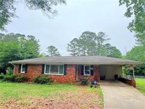 Charming single-story brick home with a covered porch and a well-maintained front yard at 5167 Hiram Lithia Springs Rd, Powder Springs, GA 30127