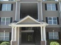 Well-maintained apartment building featuring a welcoming entrance and traditional architectural details at 8202 Fairington Village Dr, Lithonia, GA 30038
