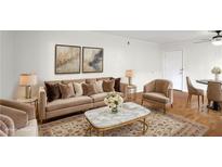 Elegant living room featuring a plush sofa, stylish decor, and ample natural light at 1150 Collier Nw Rd # K9, Atlanta, GA 30318