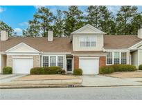 Charming townhome with attached garage, manicured landscaping, and welcoming curb appeal at 124 Camry Ln, Grayson, GA 30017