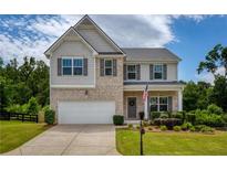 Charming two-story home with brick and siding, well-manicured lawn, and attached two-car garage at 6510 Boulder Rdg, Cumming, GA 30028