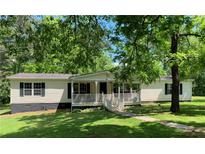 Charming single story home with front porch and mature shade trees at 6675 Millwood Rd, Cumming, GA 30041