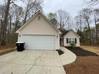 Charming single-Gathering home with a two-car garage and well-maintained front yard landscaping at 233 Winterville Dr, Rockmart, GA 30153