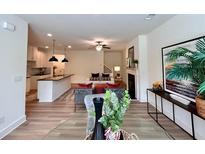 Open-concept living room with modern furnishings, a fireplace, and seamless flow into the kitchen at 1824 Emory Ln # 88, Conyers, GA 30013