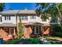 Charming brick townhome with a well-manicured lawn and inviting front porch at 8650 Hope Mews Ct, Sandy Springs, GA 30350