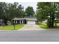 Charming single-Gathering home featuring a driveway and a well-maintained front lawn at 2645 Trotters Walk Trl, Snellville, GA 30078