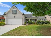Charming single-Gathering home featuring a two-car garage and well-manicured lawn at 1028 Southwood Dr, Villa Rica, GA 30180