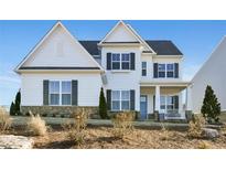 Charming two-story home with a stone foundation, black shutters, white siding, and a covered front porch at 2905 Medford Drive, Cumming, GA 30041