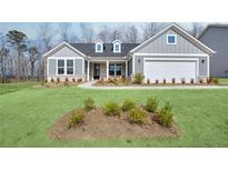 Charming single-story home with a manicured lawn, attached garage, and welcoming front porch at 2905 Medford Drive, Cumming, GA 30041