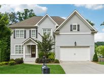 Charming two-story home featuring a well-manicured lawn and a two-car garage at 3998 Commodore Dr, Atlanta, GA 30341