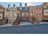 Beautiful brick townhomes with well-maintained landscaping and attached garages at 2767 Durham Ne Dr, Atlanta, GA 30319