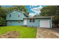 Charming two-story home featuring an attached garage and well-maintained lawn at 1328 Hoy Taylor Dr, Norcross, GA 30093