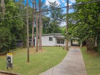 Charming one-story home with a long driveway and a well-maintained lawn at 2575 Flagstone Se Dr, Atlanta, GA 30316