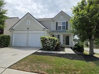 Charming two-story home featuring a two-car garage and well-maintained front yard with lush landscaping at 3613 Tinsley Sw Way, Atlanta, GA 30331