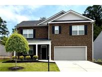 Charming two-story brick home with a well-manicured lawn and a two-car garage at 3993 Makeover Ct, South Fulton, GA 30349