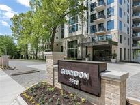 Luxury apartment building showcasing stone accents, manicured landscaping, and sophisticated entryway at 2520 Peachtree Nw Rd # 403, Atlanta, GA 30305