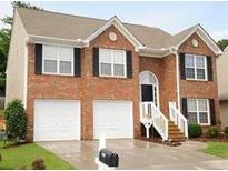 Charming two-story brick home with a two-car garage and manicured front lawn at 2918 Egret Ln, Austell, GA 30106