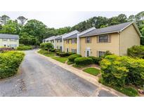 Charming townhomes featuring manicured landscaping and vibrant exteriors along quiet street at 1701 Wiscasset Pl, Tucker, GA 30084