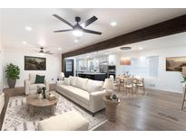 Inviting living room with modern ceiling fan, stylish furniture, and open layout to the kitchen and dining area at 1582 Pine Cir, Austell, GA 30168